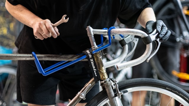 Mechanic handling a bicycle frame