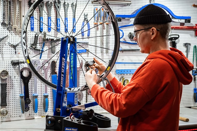 Technician repairing a bicycle in a bike shop