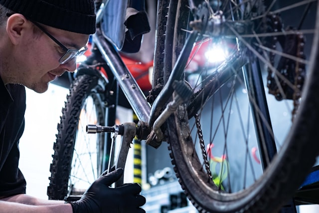 Technician servicing a bike in a garage